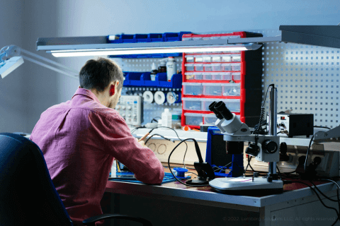 Man soldering the board - Embedded software reworking of TI CC1310 modules for noise monitoring sensors - Lemberg Solutions